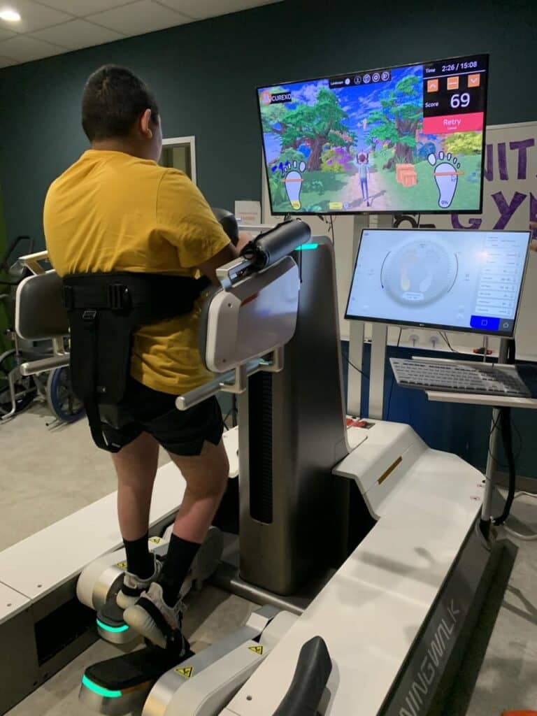 Patient at Spero Rehab exercising with the Morning Walk S200 gait training system from Curexo, installed by Harmonic Bionics.