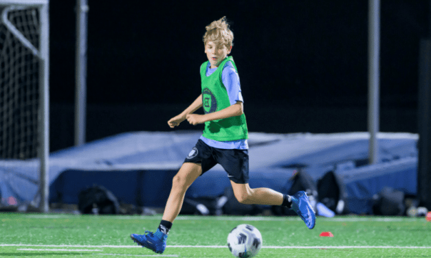 A soccer player with Delaware Football Club wears a mouthpiece equipped with sensors to monitor neck strength and head impacts when heading the ball.